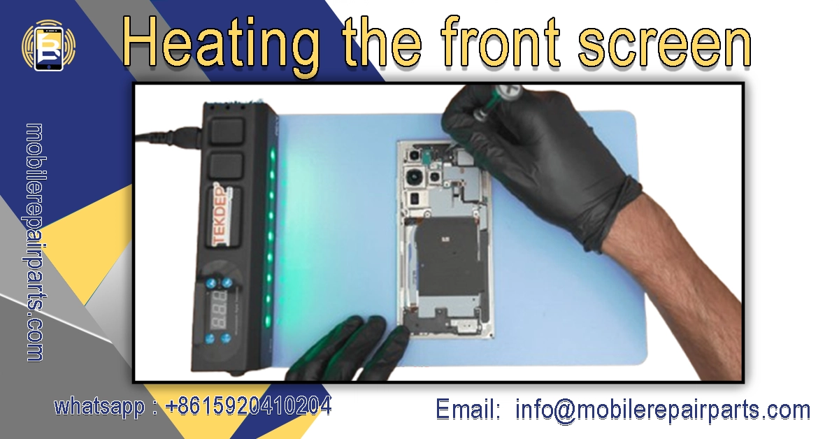 Heating the front screen of Samsung S23 Ultra with a heat gun and TEKDEP device on a repair mat for screen replacement.